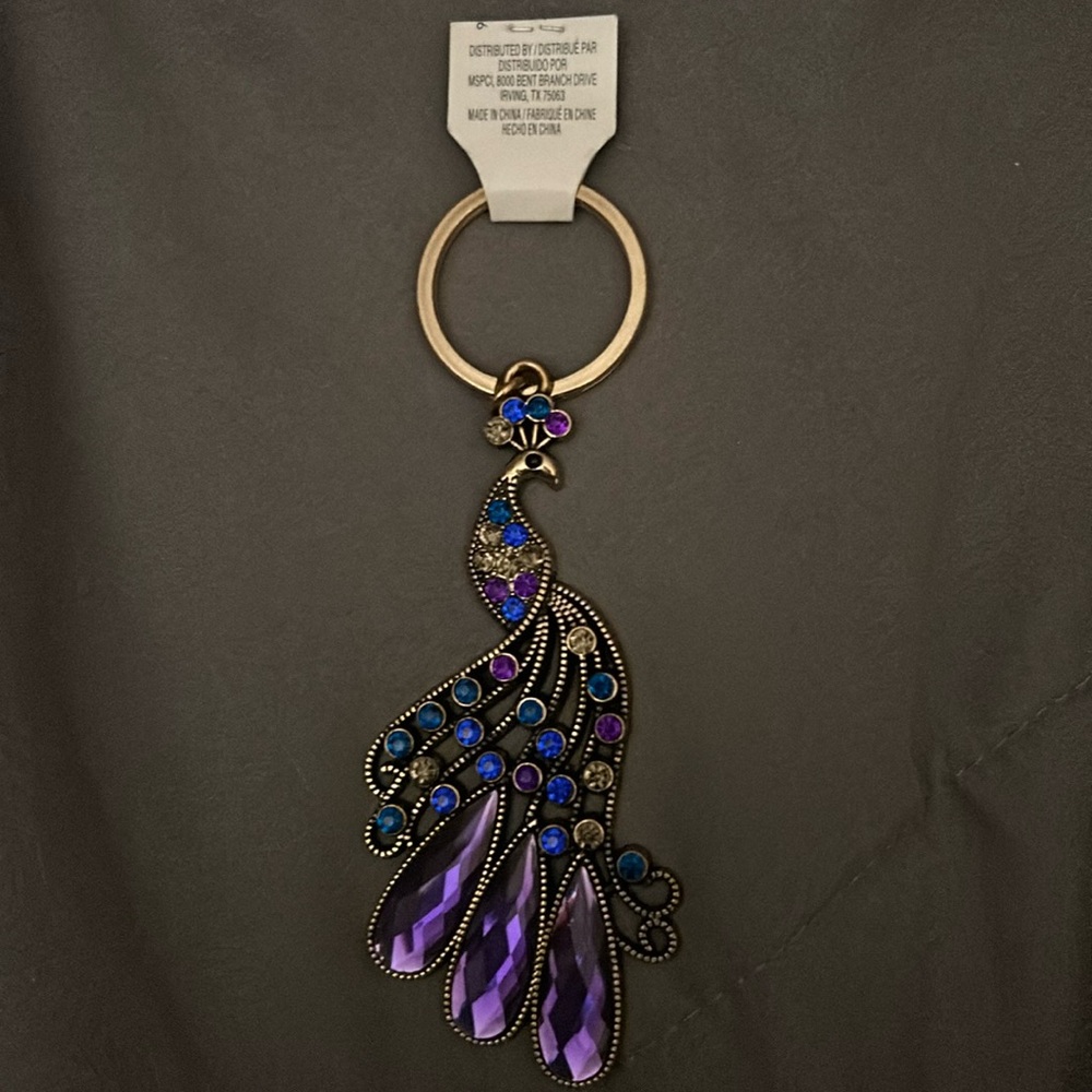 Brand new with tags purple and blue peacock keychain or pack a book zipper pull